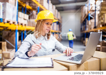 Young warehouse workers with laptop working. 37849929