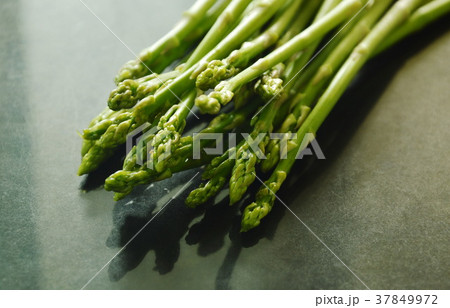 fresh green asparagus raw food on black counter fresh green asparagus raw food on black counter 37849972