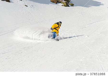 A man a snowboarder freerider descends a 37851066