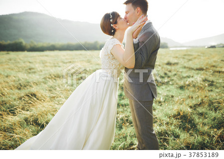 Kissing wedding couple staying over beautiful Kissing wedding couple staying over beautiful 37853189