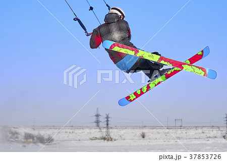 A male athlete engaged in snow kiting 37853726