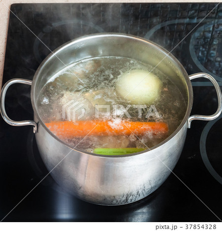 boiling meat broth in stockpot on ceramic cooker boiling meat broth in stockpot on ceramic cooker 37854328