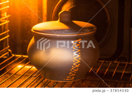 closed ceramic pot in hot electric oven closed ceramic pot in hot electric oven 37854330