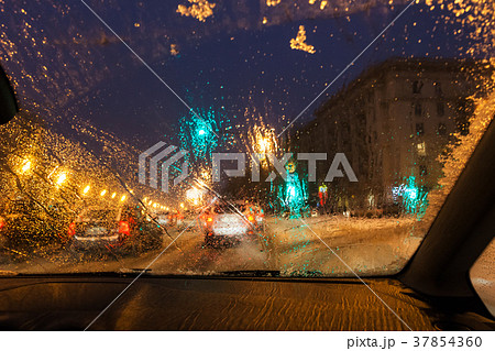 melting snow on car windshield in evening melting snow on car windshield in evening 37854360