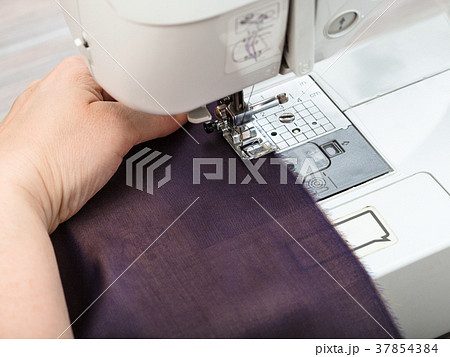 needlewoman sews strips of fabrics for patchwork needlewoman sews strips of fabrics for patchwork 37854384