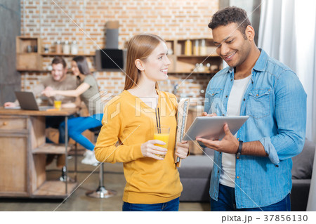 Joyful student holding her juice and a young man 37856130