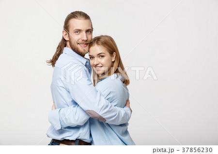 Portrait of cheerful young couple standing and 37856230