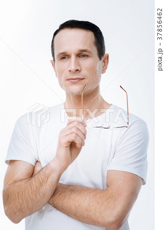 Handsome thoughtful man holding his glasses 37856462