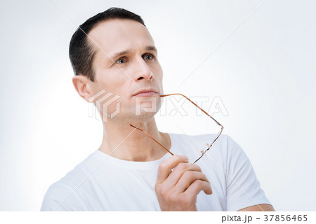 Serious smart man looking for a solution to a 37856465