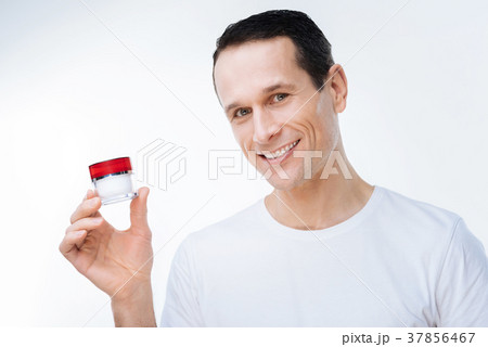 Delighted nice man using cream 37856467