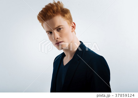 Determined young man having a stylish haircut Determined young man having a stylish haircut 37859124