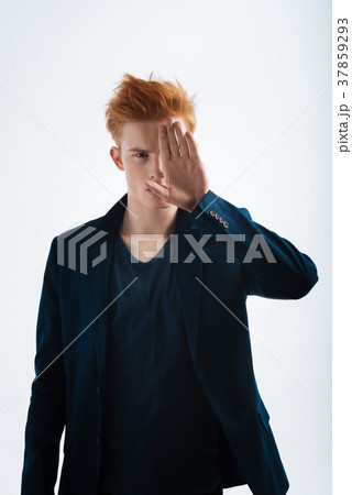 Humourless man closing his face with his palm 37859293