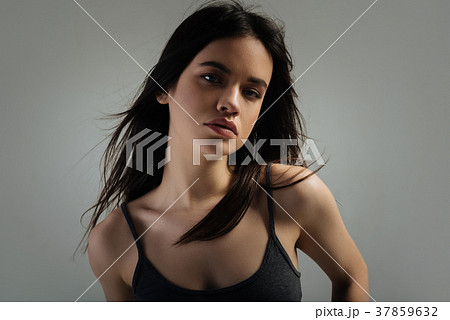 Pretty stern young woman staring 37859632