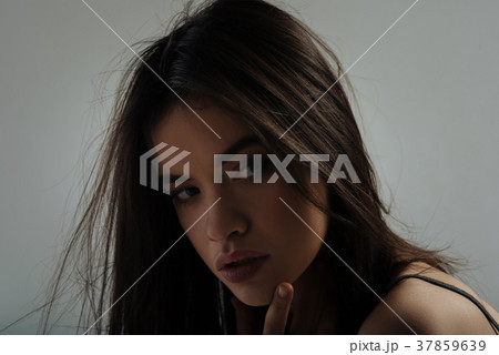 Lovely thoughtful young lady staring 37859639