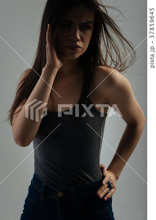 Dissatisfied young woman looking in the distance Dissatisfied young woman looking in the distance 37859645
