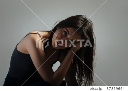 Sad woman sitting and thinking 37859664