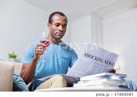 Pleasant nice man reading shocking news Pleasant nice man reading shocking news 37860085