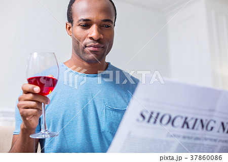 Positive joyful man reading articles Positive joyful man reading articles 37860086