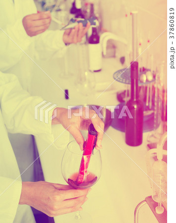Hands working in chemical laboratory checking wine qualities 37860819