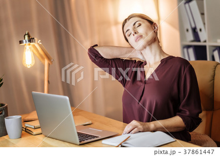 Tired businesswoman massaging her neck Tired businesswoman massaging her neck 37861447