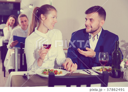 Elegant female and her boyfriend are celebrating date for dinner Elegant female and her boyfriend are celebrating date for dinner 37862491