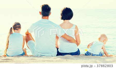 Young parents and kids sitting with back forward Young parents and kids sitting with back forward 37862803