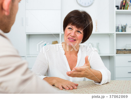 Employer discusses with elderly woman 37862869