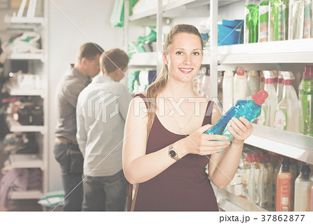 woman choosing detergent at a household goods in the store woman choosing detergent at a household goods in the store 37862877
