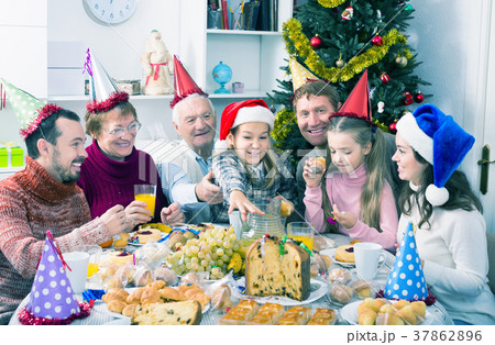 Family enjoying Christmas dinner 37862896