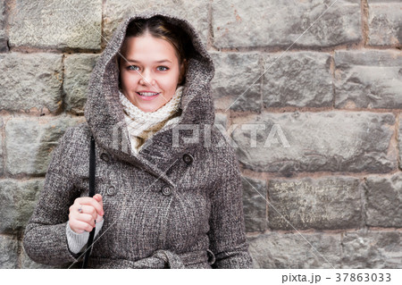 teenager girl in hood near wall teenager girl in hood near wall 37863033