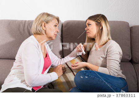 mother comforts her adult daughter mother comforts her adult daughter 37863311
