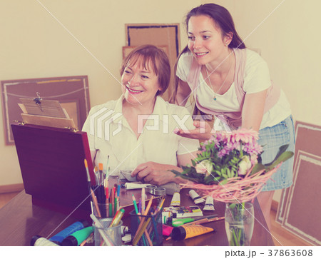 Student draws a picture with his teacher Student draws a picture with his teacher 37863608