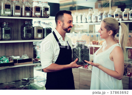 Seller and customer in store of ecological goods.] 37863692
