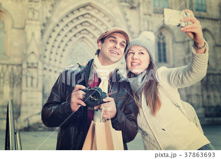 Couple man and woman in the historic center with camera and phone Couple man and woman in the historic center with camera and phone 37863693