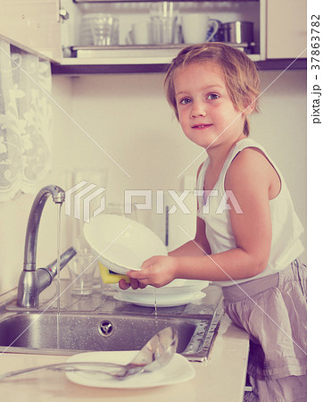 Baby girl washing dishes Baby girl washing dishes 37863782