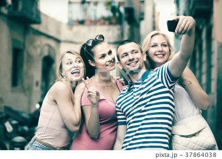 Four cheerful smiling friends taking self portrait 37864038