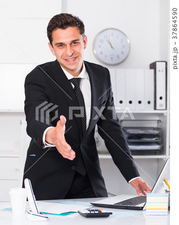 Successful businessman ready for handshake Successful businessman ready for handshake 37864590