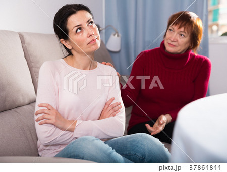 Sad mature female and daughter at sofa after quarrel 37864844