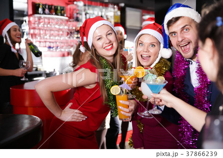 Guy with two girls on new year party in bar 37866239