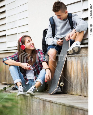 Teenage relaxing with mobile phones Teenage relaxing with mobile phones 37866302