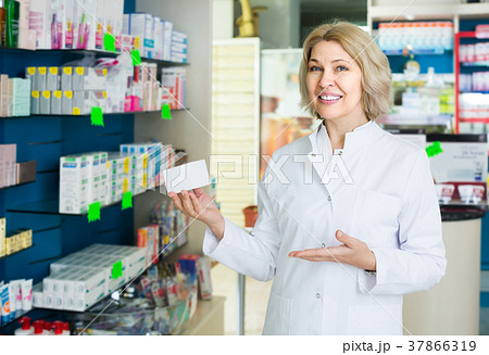 female pharmacist posing in drugstore female pharmacist posing in drugstore 37866319