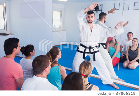 Karate coach teaching adults 37866519