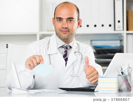 Smiling therapist in uniform filling up documents Smiling therapist in uniform filling up documents 37866807