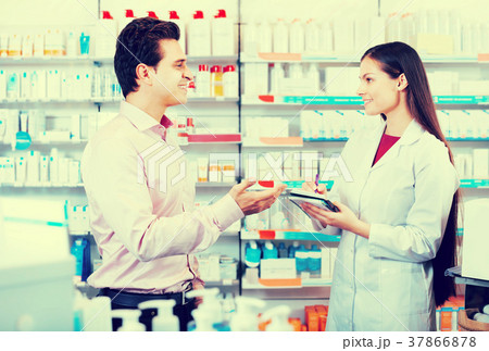 Pharmacist and consulting man in pharmacy 37866878