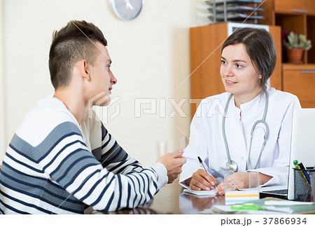 Female doctor questioning teen patient at office 37866934
