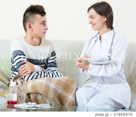 Doctor examinating teen boy with quinsy at home 37866970