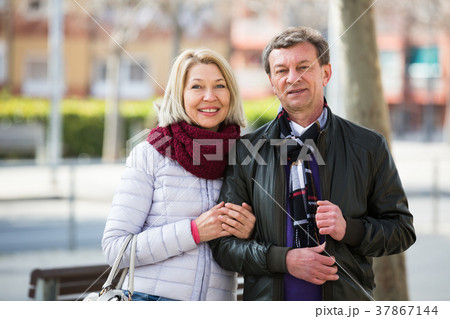 Portrait of loving elderly couple outdoors Portrait of loving elderly couple outdoors 37867144