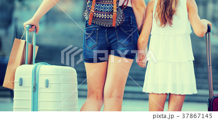 Back view of woman with daughter travelling together Back view of woman with daughter travelling together 37867145