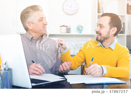 Mature man and agent sign rental agreement 37867257