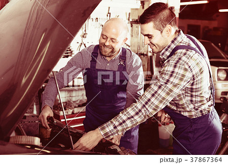 Two car mechanics at workshop Two car mechanics at workshop 37867364